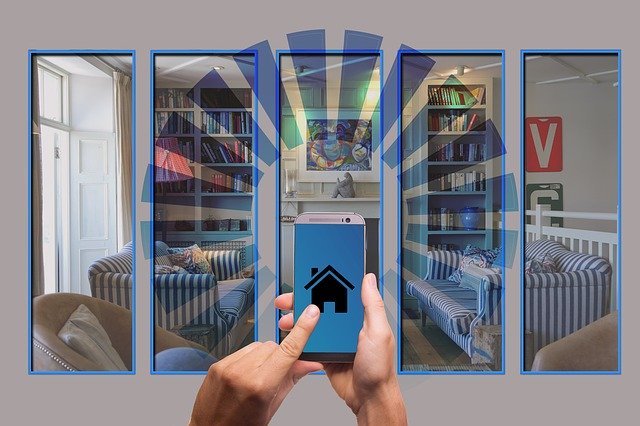 Hands holding a cell phone with a house icon, and the graphic shows signals beaming out from the house in all directions -- this is superimposed on an image of a living room with furniture bookshelves, a painting on the wall, and an open French window